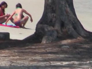 Somebody spying on two sexy babes are sun tanning on lakeshore